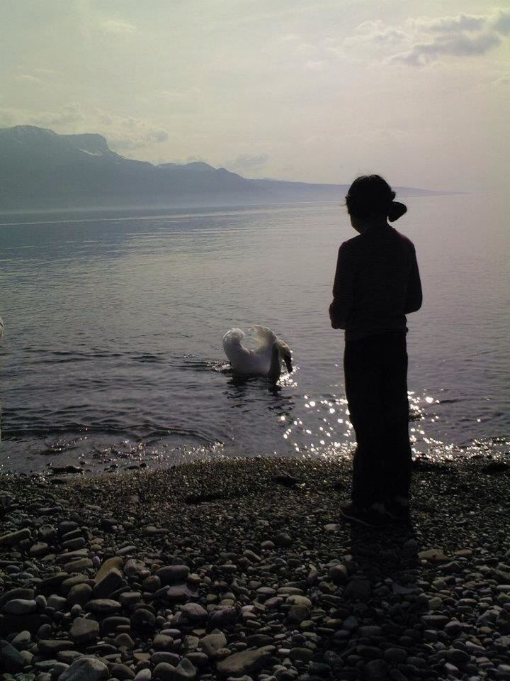 water, sky, rear view, sea, rock - object, lifestyles, leisure activity, standing, full length, tranquility, nature, men, beauty in nature, tranquil scene, scenics, shore, lake, cloud - sky