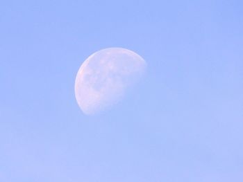 Low angle view of moon against clear blue sky