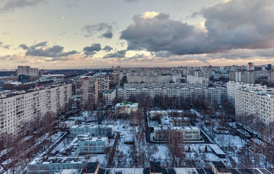 High angle view of buildings in city during sunset