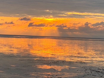 Scenic view of sea against orange sky