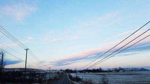 Low angle view of electricity pylon against sky