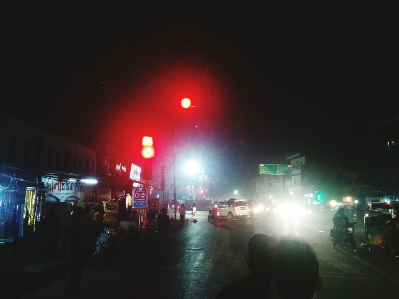 PEOPLE ON CITY STREET AT NIGHT