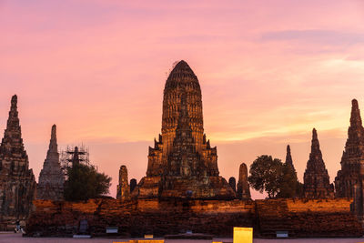 Temple against buildings at sunset