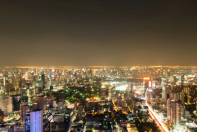 High angle view of illuminated buildings in city at night