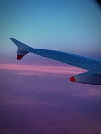 Cropped image of airplane at sunset
