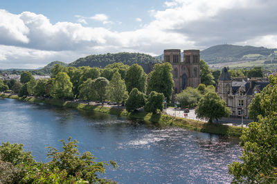 Arch bridge over river against sky