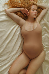 High angle view of pregnant  woman lying in bed