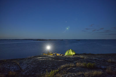 View of tourists camping at sea