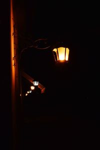 Low angle view of illuminated lamp at night