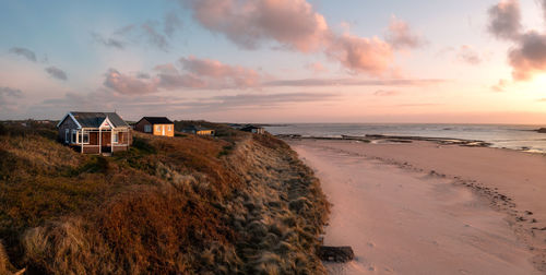 Remote beach huts with a sea view on the northumbrian sand dunes at  embleton bay beach at sunset