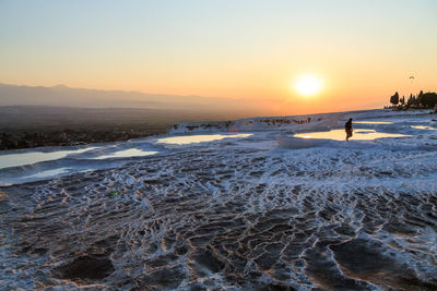 Scenic view of pools against sky during sunset