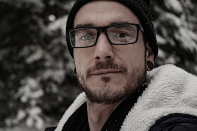 Close-up portrait of young man wearing eyeglasses