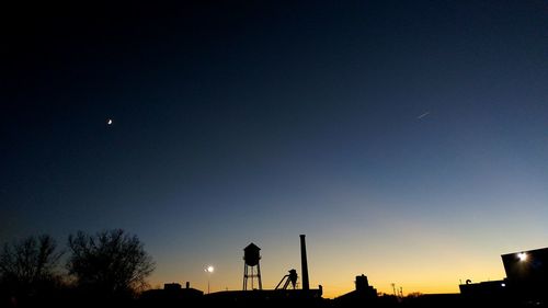 Low angle view of silhouette trees against sky at night