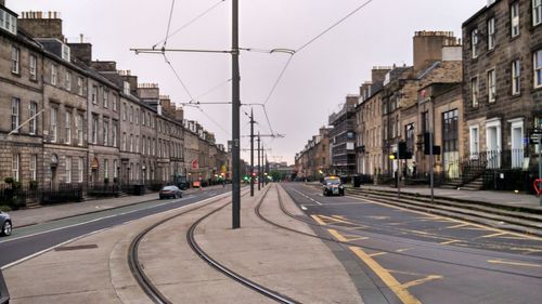 City street and buildings against sky