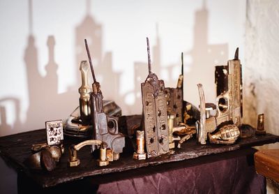 Various objects on table with shadow of city in chocolate museum