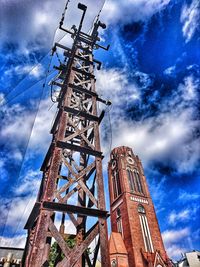 Low angle view of communications tower against sky