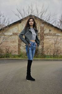 Portrait of woman standing against bare tree