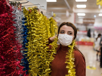 Woman wearing mask shopping at mall