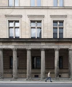 Woman walking in front of building