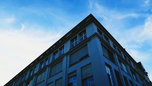 Low angle view of building against cloudy sky