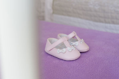 High angle view of shoes on pink board