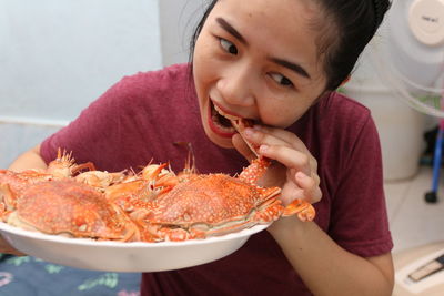 Smiling woman eating seafood
