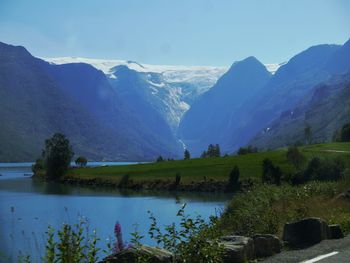 Scenic view of lake and mountains against sky