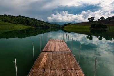 Pier over lake against sky