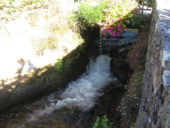 Scenic view of waterfall by sea