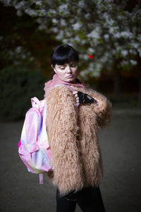 Full length of woman with pink toy standing outdoors