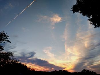 Low angle view of silhouette trees against sky during sunset