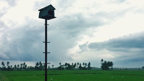 Windmill on field against sky