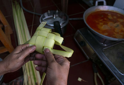 Midsection of person preparing food in kitchen