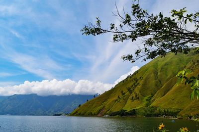 Scenic view of lake and mountains against sky