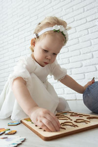 Portrait of young woman sitting on table