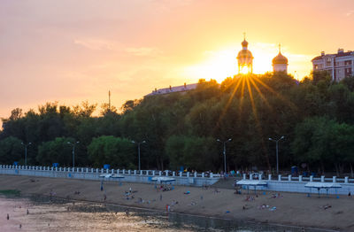 Panoramic view of people in city at sunset