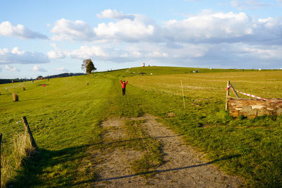 Boy in red jacket on the golf field