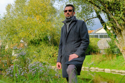 Portrait of young man against plants