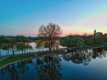 Scenic view of lake against sky at sunset