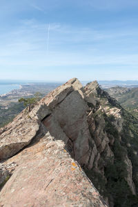 Rock formations by sea against sky