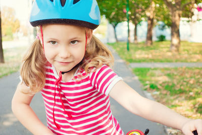 Girl wearing cycling helmet looking away