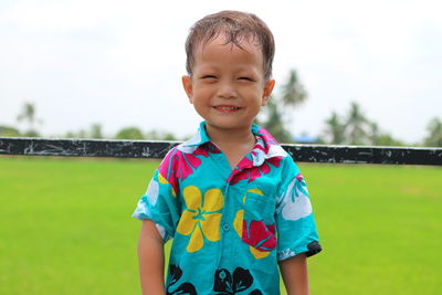 Portrait of smiling cute boy standing outdoors