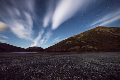 Scenic view of landscape against sky at night