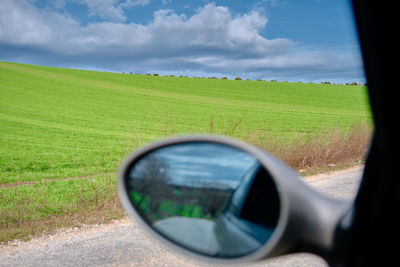 Reflection of sky on side-view mirror