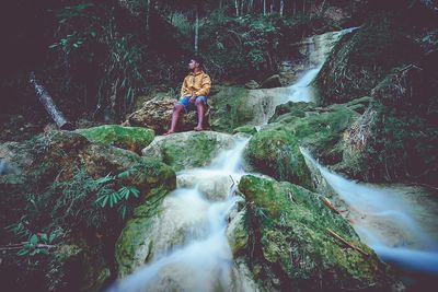 Waterfall amidst rocks in forest