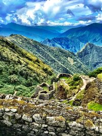 Scenic view of mountains against cloudy sky