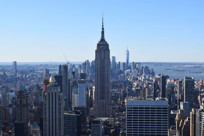 Modern buildings in city against clear sky