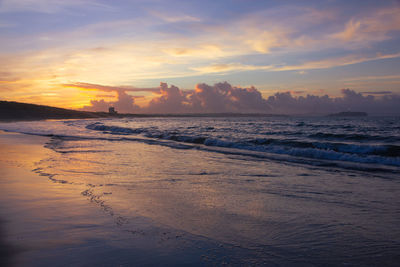 Scenic view of beach against sky during sunset