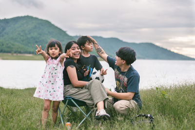 Portrait of smiling family on field