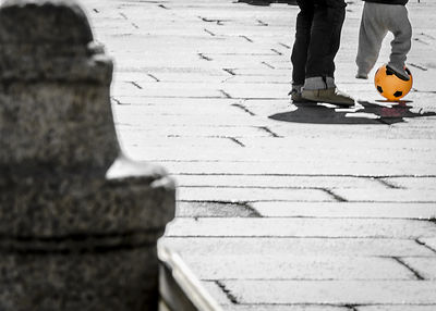 Low section of man standing on tiled floor